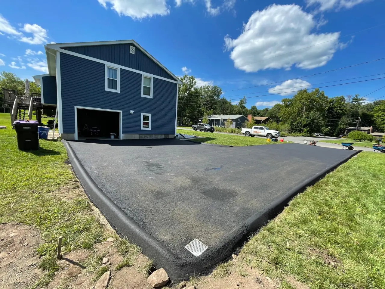 New asphalt driveway installation for a Massachusetts home